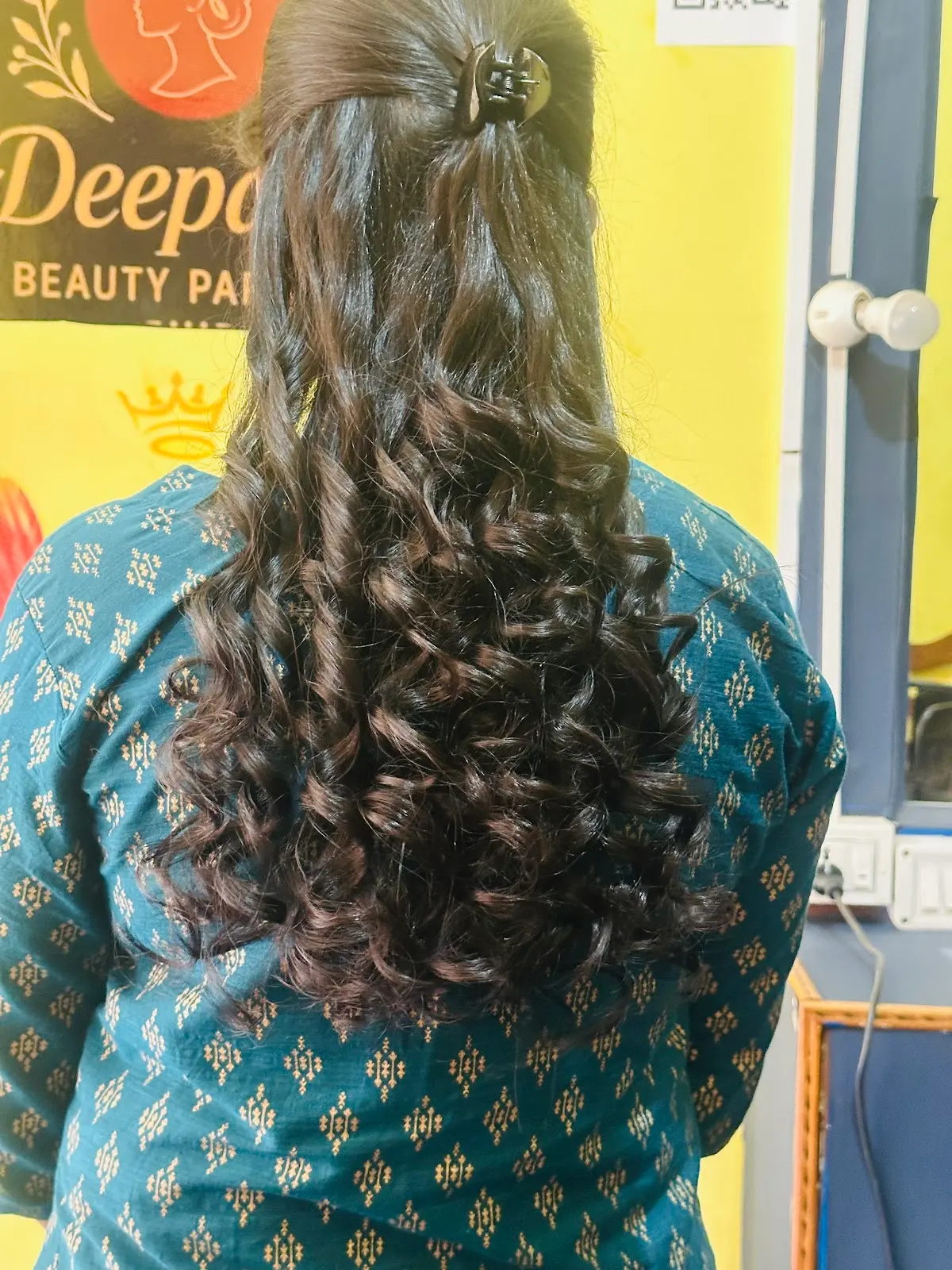 Long waved hair, seen from behind, in front of the parlour sign